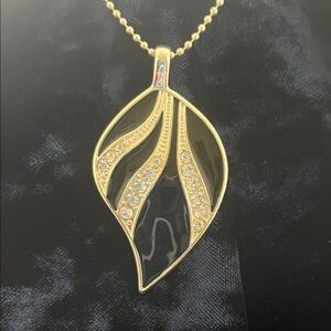 Black, silver tone, with CZ embellishment. Leaf shape pendant.